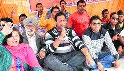 BJP workers protest at Balliwala Chowk against irregularities in construction of flyovers in Dehradun on Saturday. tribune photo: Abhyudaya Kotnala