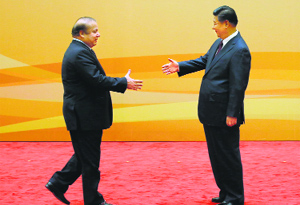 Chinas President Xi Jinping (R) with Pakistans Prime Minister Nawaz Sharif in Beijing on Saturday.