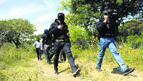 Members of the Federal Police search for the missing 43 students of Ayotzinapa Teacher Training College in Tianquizolco.