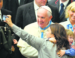 Pope Francis poses for a selfie at the Vatican.