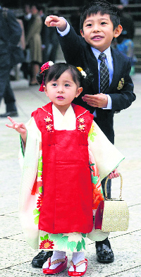 A kimono-clad girl poses during an annual festival at Meiji Jingu Shrine in Tokyo on Saturda. Japanese families celebrate the traditional event by dressing up their children and visit shrines to celebrate childrens growth and pray for their future well-being.