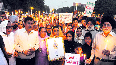Residents take out a candle march in Mohali on Sunday. 
