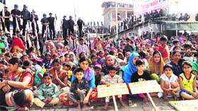 Followers of Sant Rampal surrounded by personal security guards outside Satlok Ashram in Barwala town of Hisar on Sunday