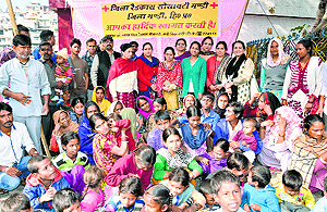 Migrant people with a team of the Red Cross Society in Mandi on Saturday
