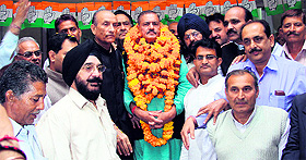 MLA Jagdish Raj Sapolia joins the Congress during a function in Jammu on Sunday. 