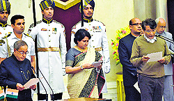 President Pranab Mukherjee administers the oath of office to Suresh Prabhu as a Cabinet minister in New Delhi on Sunday