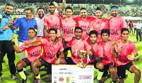 The Indian Oil players pose with the trophy after winning the Surjit Hockey title.