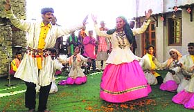 Artistes present a folk dance and song programme during the 14th state foundation day in Mussoorie on Sunday