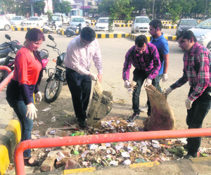 Volunteers of an NGO carry out a cleanliness drive at the Ranjit Avenue market in Amritsar on Monday.