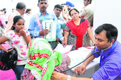 A doctor examines a patient during a health check-up camp at Sector 15, Chandigarh. Tribune photo: Pradeep Tewari