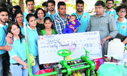NavSankalp, a student-run charity association, donates a cheque for ~70,000 to Jasmine at Sector 10 in Chandigarh on Monday. Tribune Photo: Pradeep Tewari