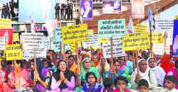 Rampal followers squat outside Satlok ashram in Hisars Barwala town on Monday. Photo: Bansi Lal Basniwal