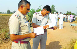 Cops at the crime scene in Sheria village of Jhajjar on Monday. Photo: Sumit Tharan