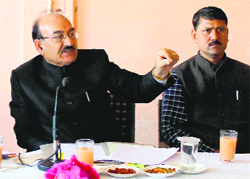Health Minister Kaul Singh Thakur addresses a meeting at Padhar in Mandi on Monday.