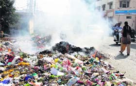 Illegal: Residents burn garbage due to the ongoing controversy over the solid waste management system in Jalandhar on Monday