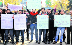 Teachers hold placards during a demonstration in Srinagar on Monday.