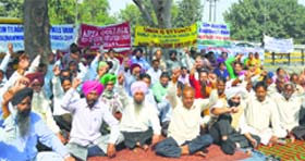 Members of the Private College Non-Teaching Employees’ Union protest in front of the DC office in Ludhiana on Monday