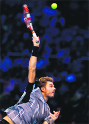 Stanislas Wawrinka serves to Tomas Berdych during their match on Day two of the ATP World Tour Finals in London on Monday.