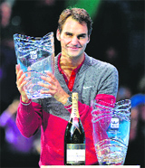 Rodger Federer poses for pictures after he was presented with the Stefan Edberg Sportsmanship Award and the ATP World Tour Fans Favorite Award on Sunday.