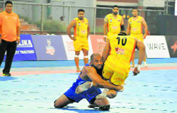 A United Singhs player tries to stop a Yo Yo Tigers raider in their WKL match in Ludhiana on Monday.