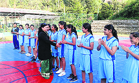 Principal of Aryan School, B Dasgupta, interacts with basketball players before the beginning of the match in Dehradun on Monday. 