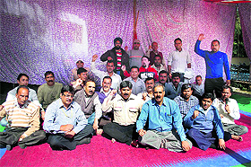 Ordnance employees hold a dharna in Dehradun on Monday. 