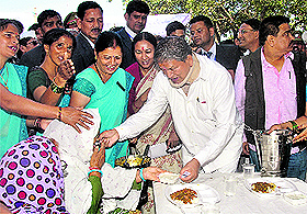 Chief Minister Harish Rawat feeds an old woman at the inauguration of the CM Old Women Food Scheme at Charba village near Dehradun on Monday. 