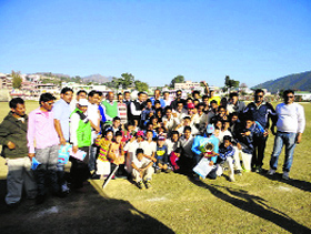 Pithoragarh cricket team along with their winning trophy on Monday. 