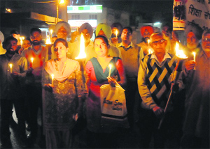 Members of the Kul Hind Shikhya Adhikar Manch take out a candle light march in Bathinda on Tuesday.