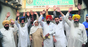 Farmers protest against Cooperative Bank officials at the grain market in Bathinda on Tuesday.