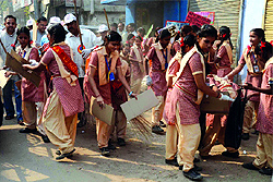 Students of SD Harimandir School at Paharganj in Central Delhi clean the road under the Swachh Bharat campaign on Tuesday