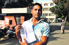 Palwinder Singh shows his overcharged electricity bill