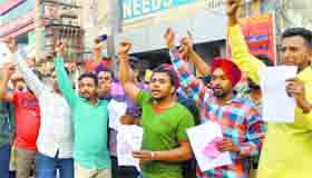 Immigration fraud victims hold a protest in front of the office of a travel agent at Dugri.