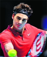 Rodger Federer returns to Kei Nishikori during their Group B match of the ATP World Tour Finals in London on Tuesday