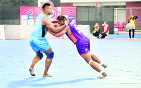 A California Eagles player (left) tries to stop a Vancouver Lions raider during their WKL match in Ludhiana on Tuesday