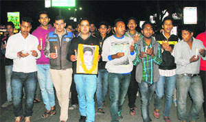 Members of the NSUI hold a candle march at Gandhi Park in Dehradun on Tuesday.