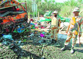 Pakistani Rangers are pictured at the scene of a bus accident near the city of Khairpur, 450 km from Karachi, on Tuesday