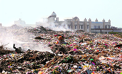 The wall of a college adjoining the boundary of the dump yard