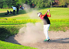 A golfer plays a bunker shot during the first leg of the CGA Juniors Golf Tournament in Panchkula on Wednesday. 