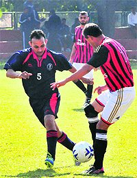 Players vie for the ball during a football match between AG Uttarakhand and AG Punjab at Sector 17 in Chandigarh on Wednesday.