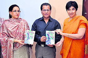 Madhvi Kataria, additional director, Department of Local Bodies, Punjab, (left) releases the book written by Dr Khalid Javed Jan (centre) in Chandigarh.
