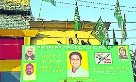 A hoarding of PDP candidate from Jammu East Bharat Choudhary in old Jammu city.