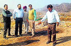 A team of the Municipal Corporation at the Wariana dump in Jalandhar on Wednesday. 