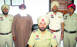 The proclaimed offender in police custody in Jalandhar on Wednesday
