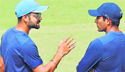 Stand-in captain Virat Kohli seems to be telling Robin Uthappa what he expects from him, on the eve of the ODI in Kolkata. PTI 