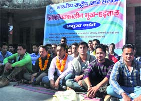 Members of the NSUI sit on a hunger strike at DAV PG College in Dehradun on Wednesday