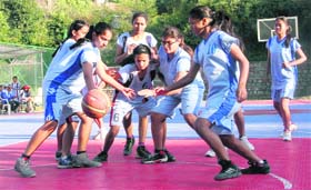 WARPATH: Players of Carmen School and The Aryan School battle to take control of the ball during a match in the DDCSA Senior Girls Basketball Tournament at The Aryan School in Dehradun on Wednesday