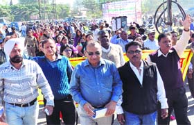 Bank employees hold a protest march at Parade Ground in Dehradun on Wednesday