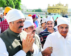 Union Minister of State Vijay Sampla (left) pays obeisance at the Golden Temple in Amritsar on Thursday.