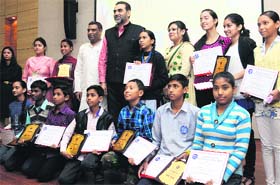 Children from the economically weaker section awarded by Chandigarh BJP president Sanjay Tandon (fifth from left) for their achievements in various fields during a function at the Beant Singh Memorial Centre for Visual and Performing Arts, Sector 42, on Thursday